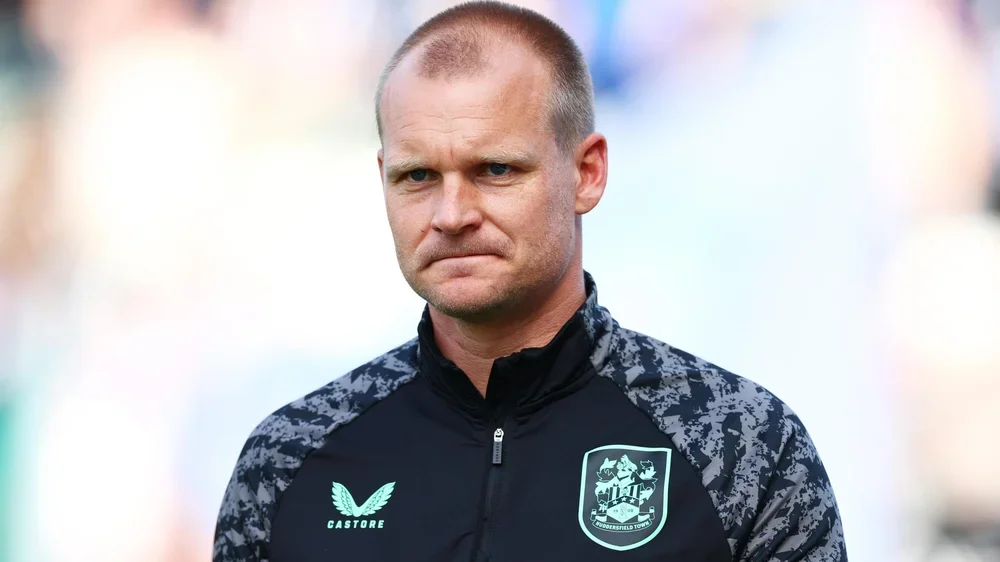 Outgoing Huddersfield Town manager Liam Manning in a club-issued tracksuit top